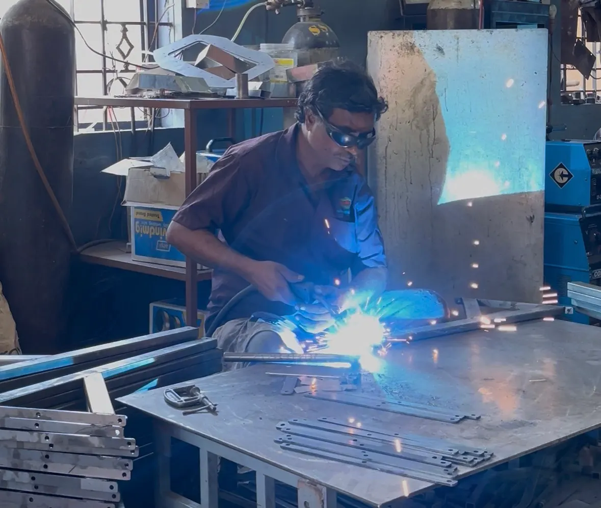 Welder performing TIG welding on a sheet metal enclosure seam
